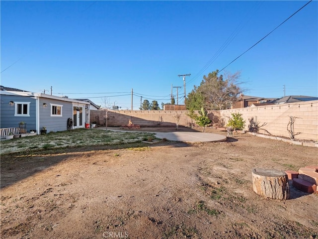 view of yard with a patio area and a fenced backyard