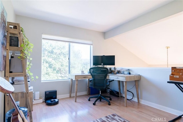 office area featuring vaulted ceiling with beams, baseboards, and wood finished floors