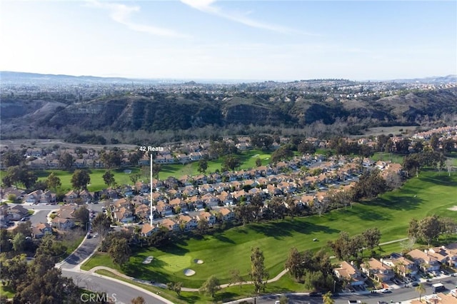 drone / aerial view with a residential view and golf course view