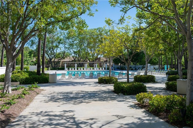 surrounding community with fence and a swimming pool