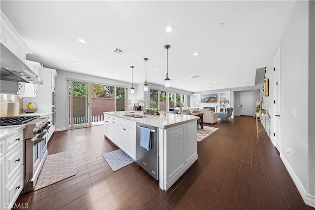 kitchen with visible vents, white cabinets, appliances with stainless steel finishes, light countertops, and a sink