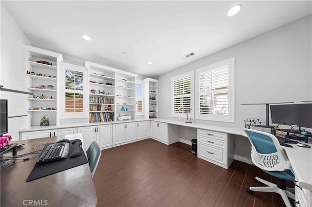 office area featuring recessed lighting, visible vents, dark wood finished floors, and built in study area