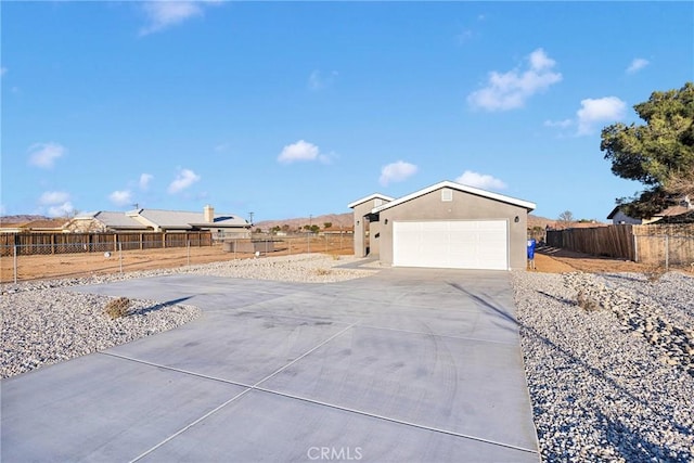 exterior space featuring concrete driveway and fence