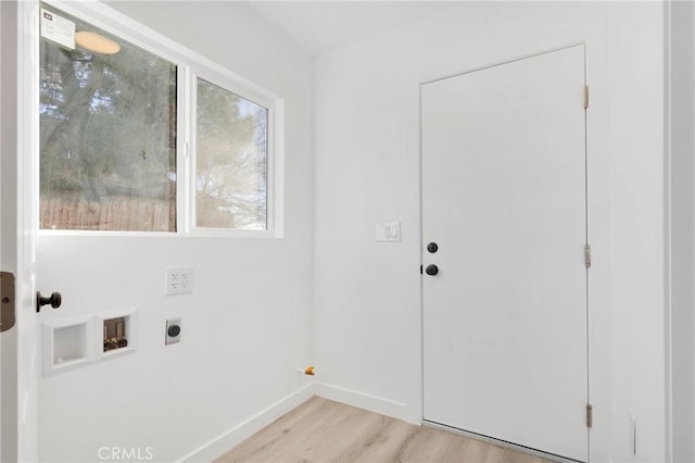 clothes washing area with hookup for a washing machine, laundry area, baseboards, light wood-style floors, and electric dryer hookup