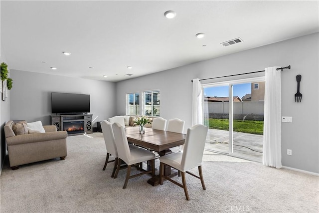 dining space featuring light colored carpet, visible vents, baseboards, and recessed lighting