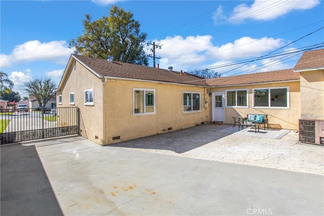 back of house featuring a patio, central air condition unit, fence, crawl space, and stucco siding