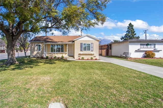 ranch-style home with covered porch, concrete driveway, a front lawn, and stucco siding