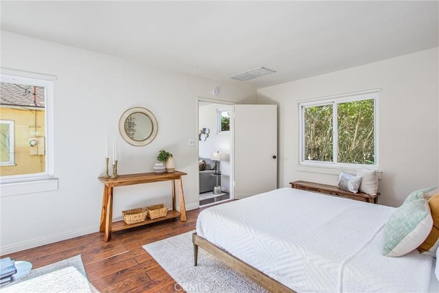 bedroom featuring dark wood-type flooring, visible vents, and baseboards