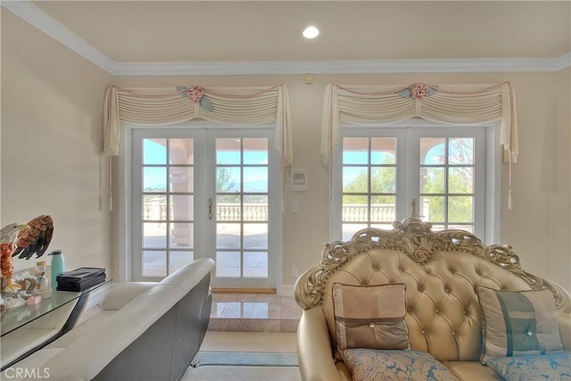 doorway with ornamental molding and french doors