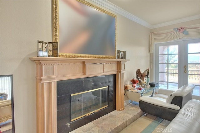 living room featuring ornamental molding, french doors, and a tiled fireplace