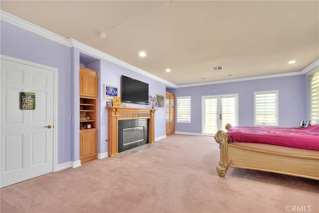 bedroom with baseboards, visible vents, light colored carpet, ornamental molding, and a high end fireplace