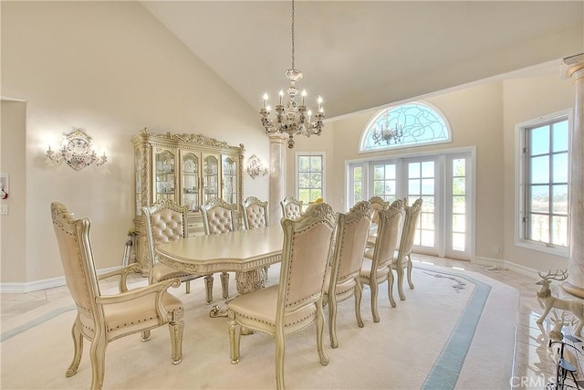 dining area featuring a chandelier, high vaulted ceiling, french doors, and a wealth of natural light