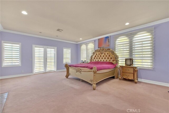 carpeted bedroom featuring visible vents, multiple windows, and ornamental molding