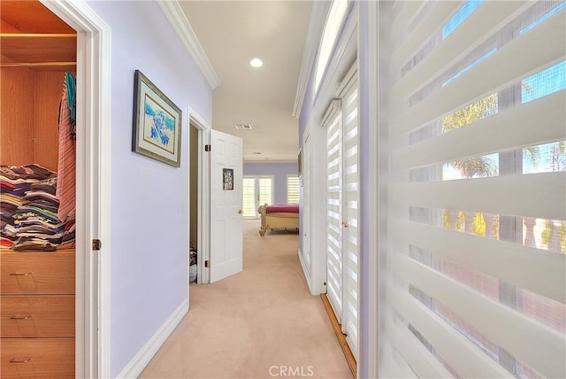 corridor with light carpet, baseboards, visible vents, ornamental molding, and recessed lighting