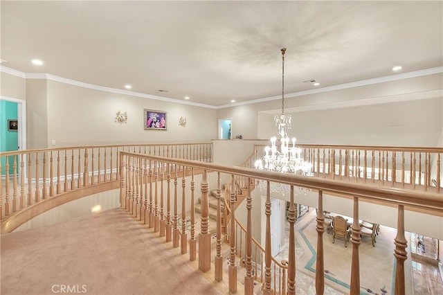 corridor with ornamental molding, an inviting chandelier, an upstairs landing, carpet floors, and recessed lighting