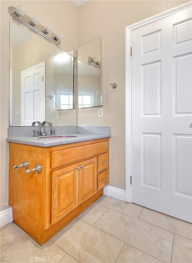 bathroom with tile patterned flooring and vanity