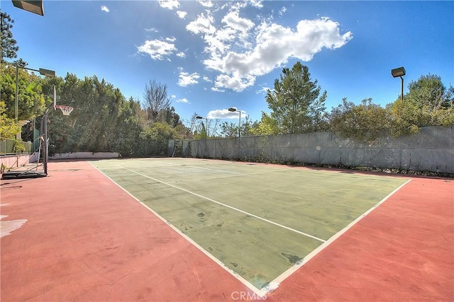 view of sport court featuring fence