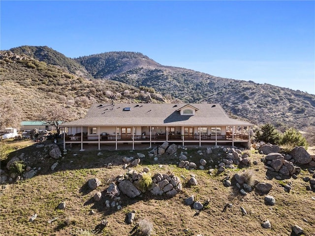 back of house featuring a mountain view