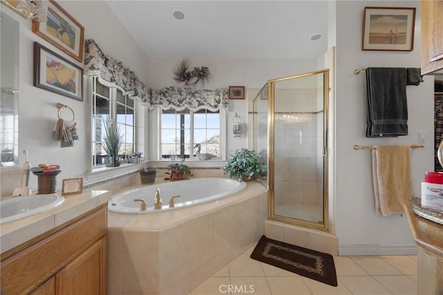 bathroom featuring a garden tub, a stall shower, tile patterned flooring, and vanity