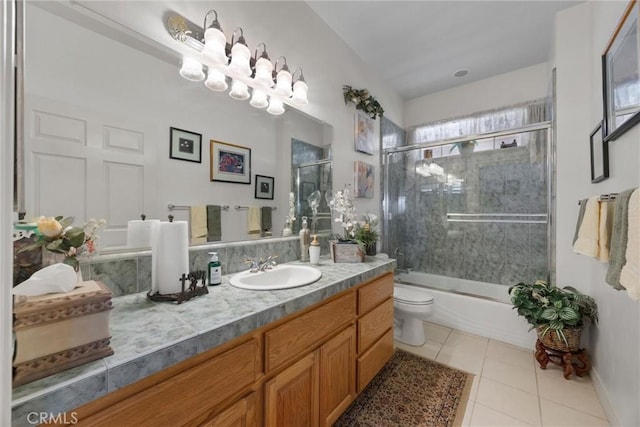 bathroom with bath / shower combo with glass door, vanity, toilet, and tile patterned floors