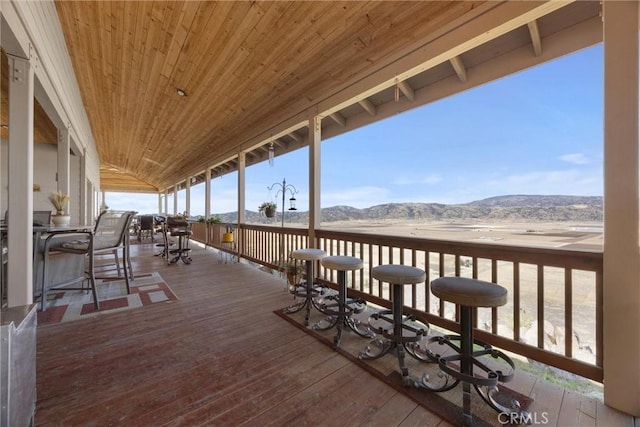 deck featuring a mountain view and a bar