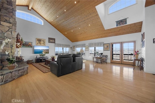 living area with high vaulted ceiling, wooden ceiling, french doors, light wood-type flooring, and beamed ceiling