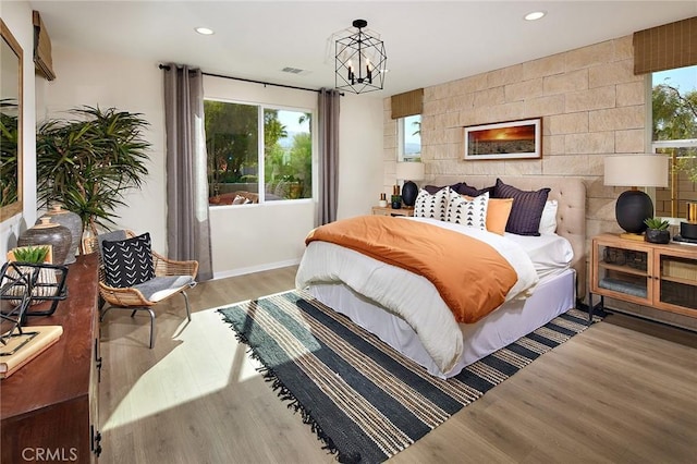 bedroom featuring recessed lighting, multiple windows, and light wood-style flooring