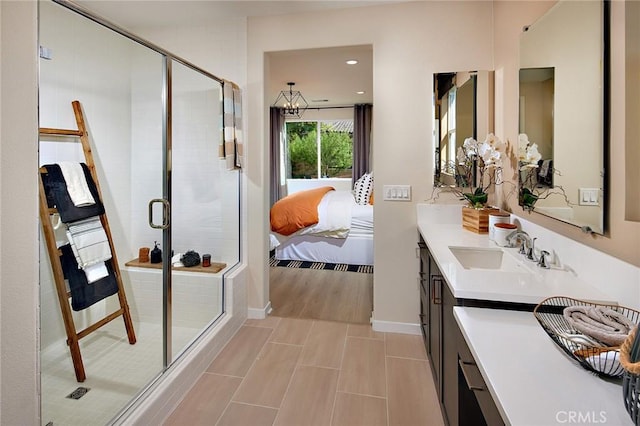 ensuite bathroom featuring a shower stall, recessed lighting, vanity, and ensuite bathroom