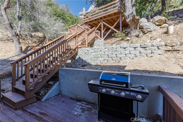 wooden deck with a grill and stairs