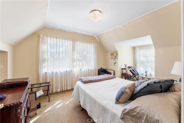 bedroom with lofted ceiling and light colored carpet