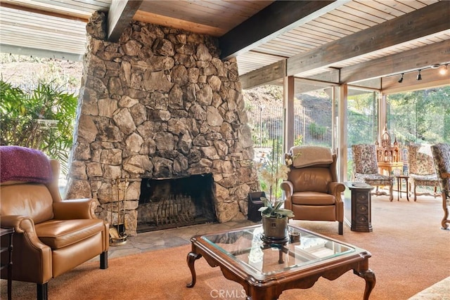 living room with beamed ceiling, a fireplace, wooden ceiling, and light colored carpet