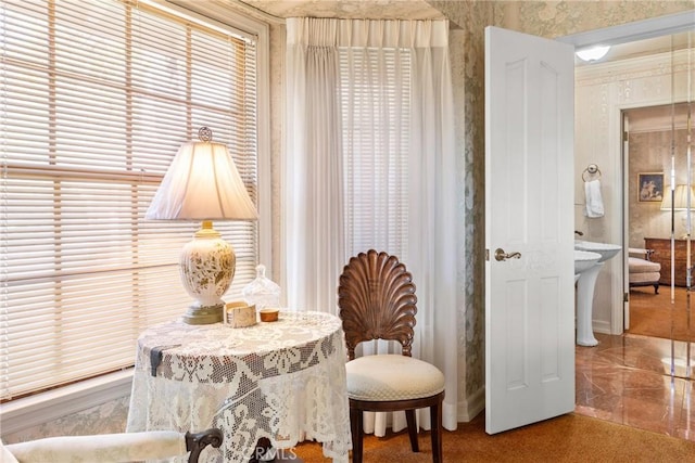 sitting room with wallpapered walls