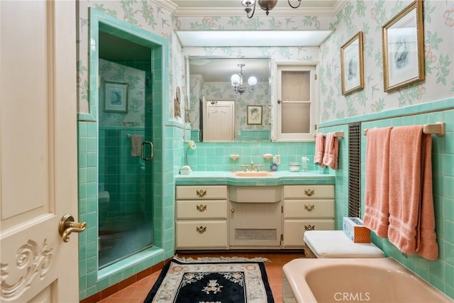 bathroom featuring wallpapered walls, a wainscoted wall, vanity, a shower stall, and a bath