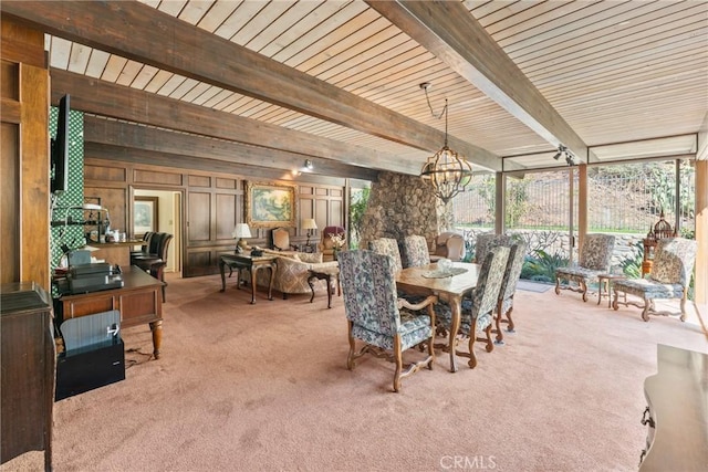 carpeted dining area with expansive windows, beamed ceiling, and an inviting chandelier