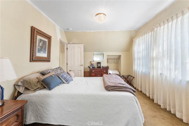 bedroom featuring lofted ceiling and light colored carpet