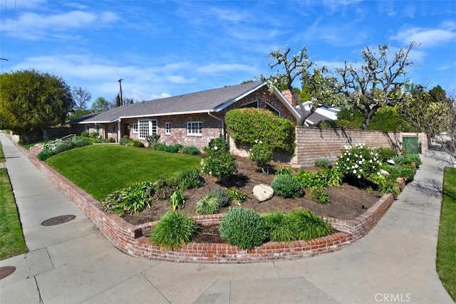 view of side of home with a yard and fence