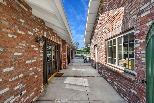 view of home's exterior with brick siding and a patio area