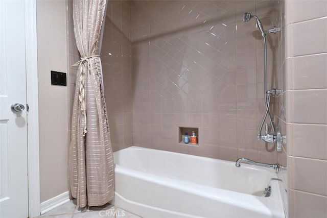 bathroom with shower / tub combo and tile patterned flooring