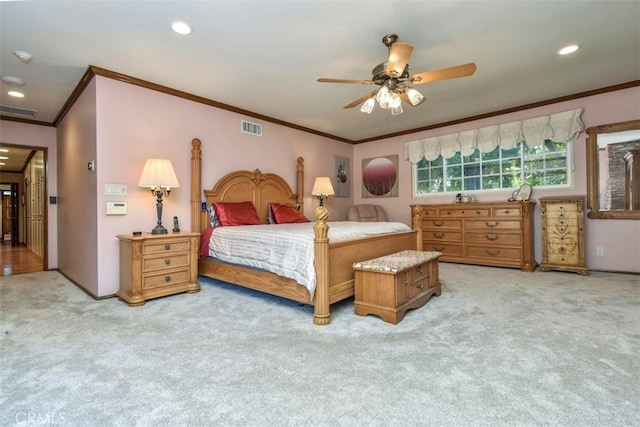 bedroom with recessed lighting, visible vents, ornamental molding, and light colored carpet