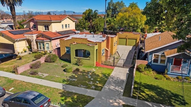 view of front of home featuring a gate, a residential view, fence, and stucco siding