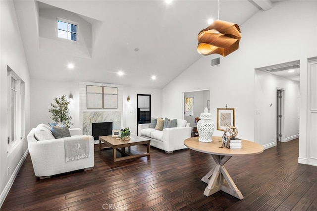 living room featuring high vaulted ceiling, a high end fireplace, dark wood-style flooring, and visible vents