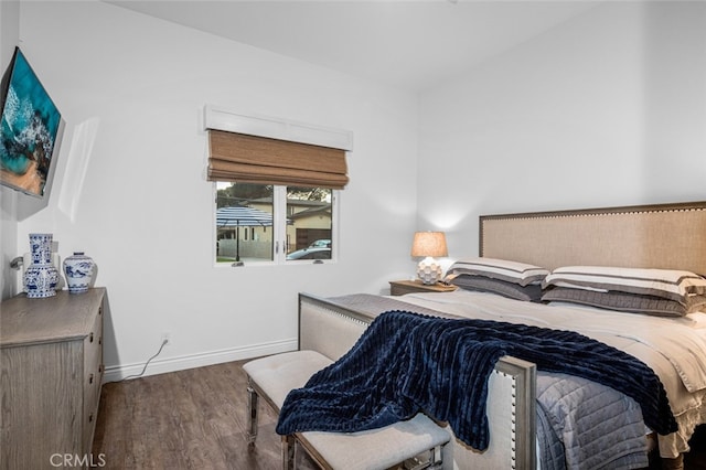 bedroom featuring baseboards and wood finished floors