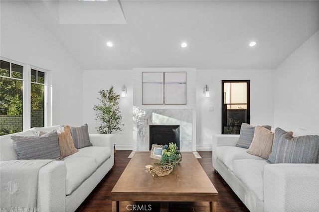 living room with a fireplace, vaulted ceiling, dark wood-style flooring, and recessed lighting