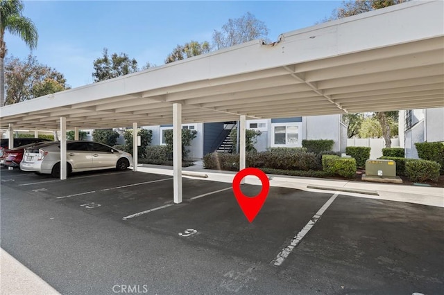 covered parking lot featuring stairs