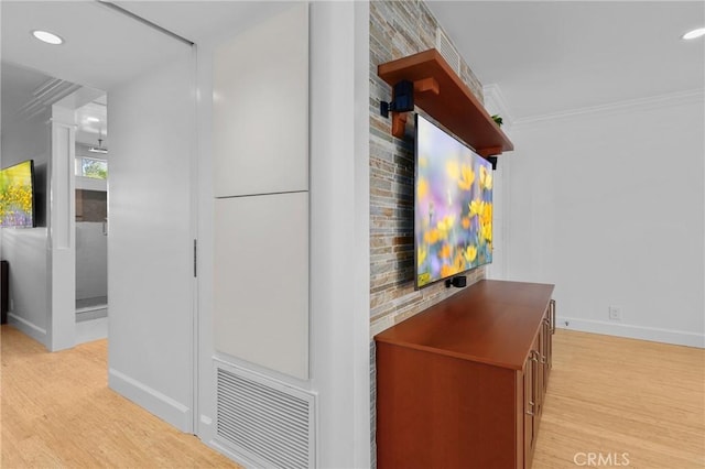 interior details featuring ornamental molding, wood finished floors, and visible vents