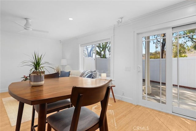 dining space with baseboards, recessed lighting, light wood-style flooring, and crown molding