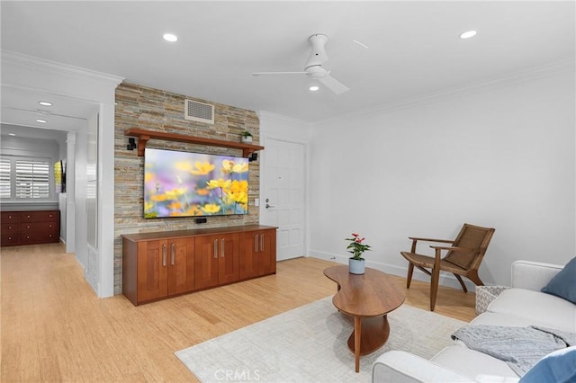 living room with recessed lighting, visible vents, crown molding, and light wood-style flooring