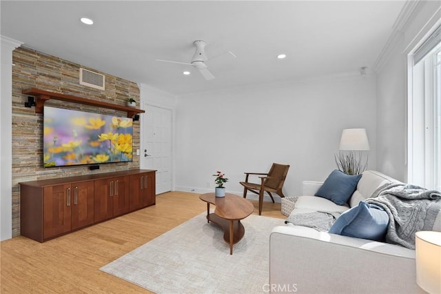 living area with ceiling fan, ornamental molding, light wood-type flooring, and recessed lighting