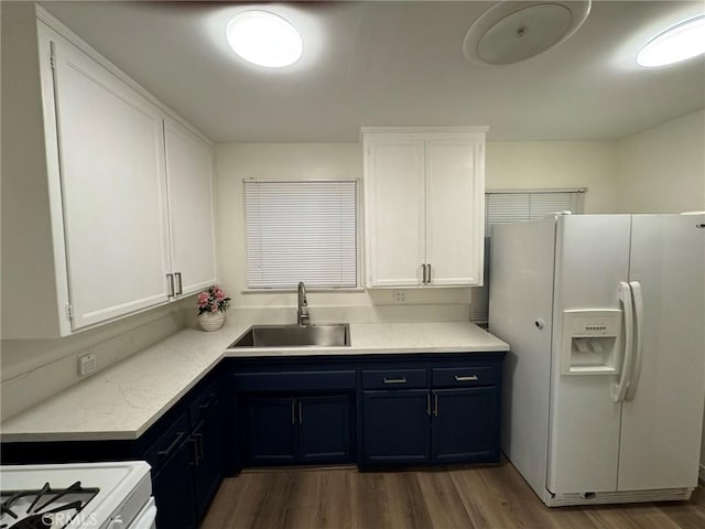 kitchen featuring light countertops, white appliances, a sink, and white cabinets