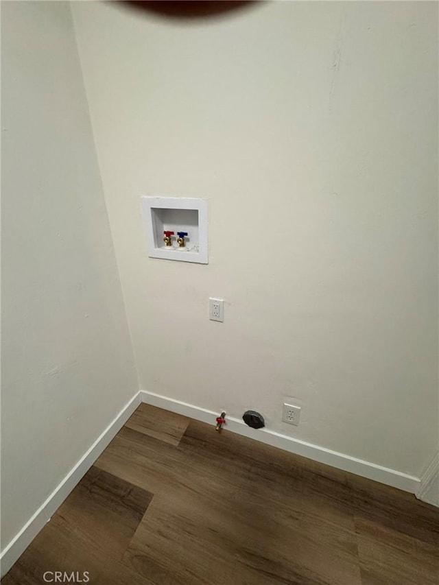 clothes washing area featuring washer hookup, laundry area, dark wood finished floors, and baseboards